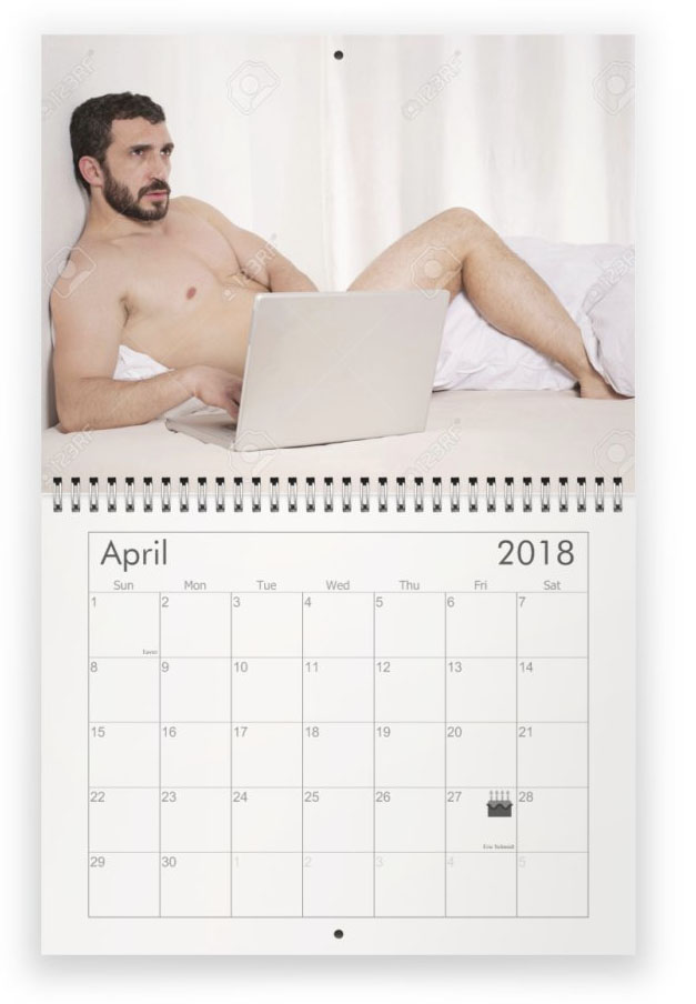April. Naked young guy with beard and laptop on bed